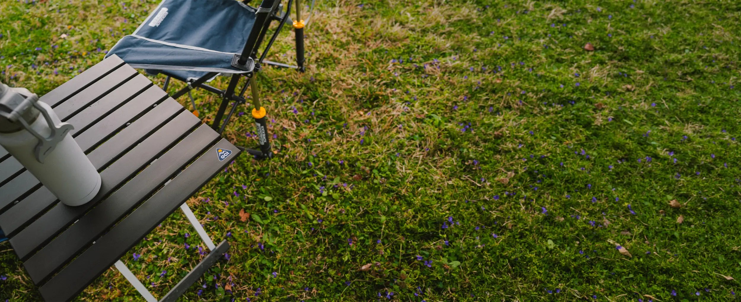 Top view of a Compact Camp Table with an outdoor water bottle.